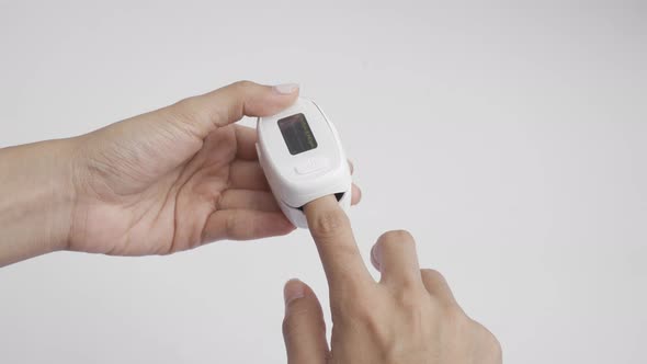 Hand with pulse oximeter or blood oxygen level measure monitor device with display