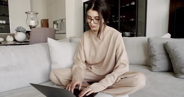 Woman Using Laptop at Home