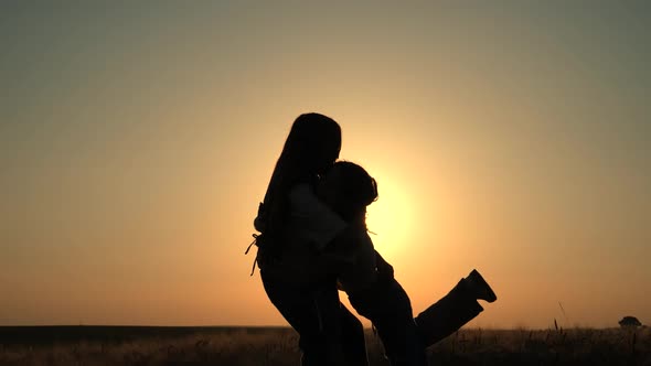 Two young girls hug, have fun outside