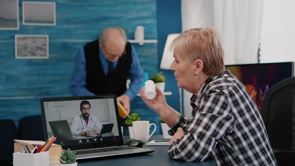 Remote Doctor Using Webcam Prescribing Medicine to Sick Aged Woman