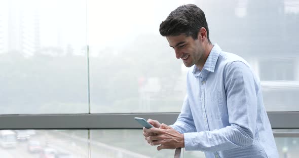 Caucasian man use of cellphone at outdoor