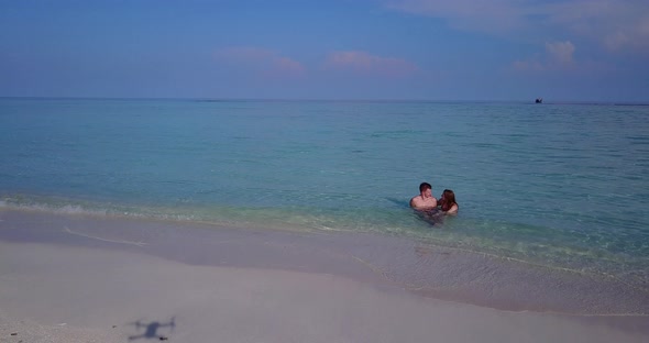 Happy lady and man married on vacation enjoy life on beach on white sand background