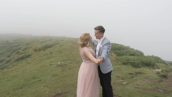 Couple dancing on a hill