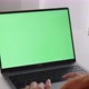 Young Asian woman using laptop computer at home with green blank monitor screen. - VideoHive Item for Sale