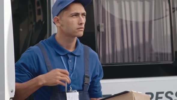 Young Man Delivering Package to Customer