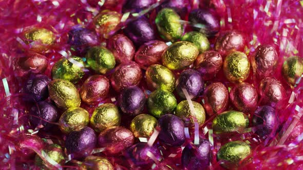 Rotating shot of colorful Easter candies on a bed of easter grass - EASTER