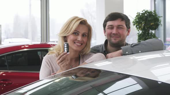 Beautiful Happy Mature Couple Posing Near Their New Auto Holding Car Keys