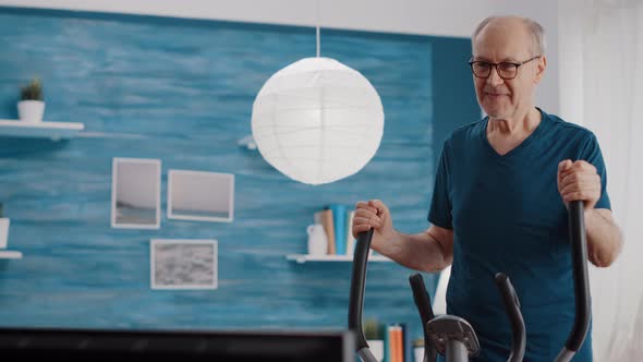 Close Up of Senior Man Training with Stationary Bicycle