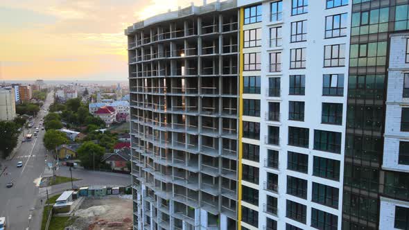 High Residential Apartment Building with Monolithic Frame Under Construction at Sunset