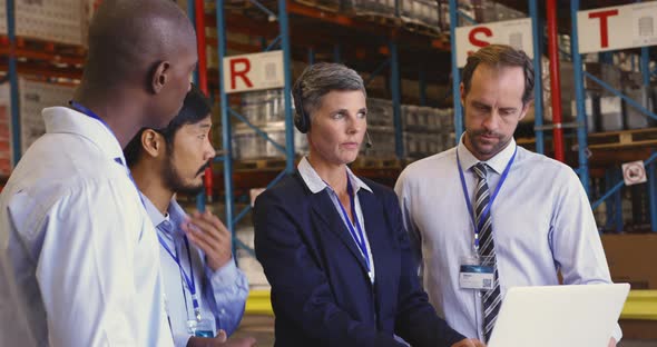 Managers and staff having a meeting in a warehouse loading bay 4k