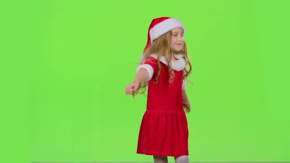 Child Girl Is Spinning in Her New Year's Costume. Green Screen