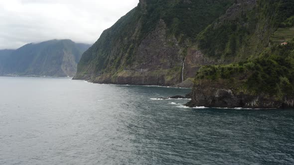 Aerial is flying along the coast of Seixal, Madeira.