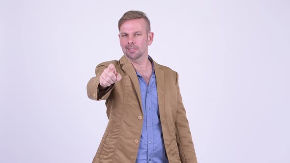 Happy Blonde Casual Businessman Pointing To Camera