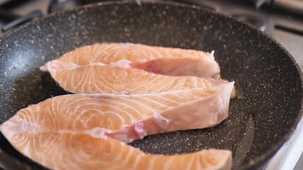 Red Fish in a Frying Pan Cook Sprinkles Salt Salmon Fish