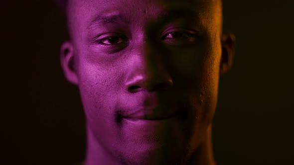 African American Guy Biting Lips Sensually Posing In Dark Studio