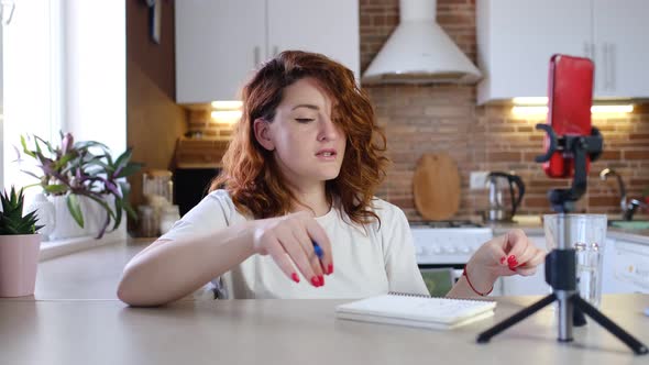 Female Blogger is Recording Video with Smartphone Camera