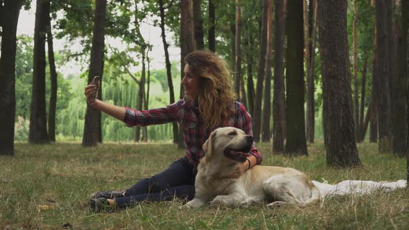 Pretty Girl Is Making Selfie with Her Labrador