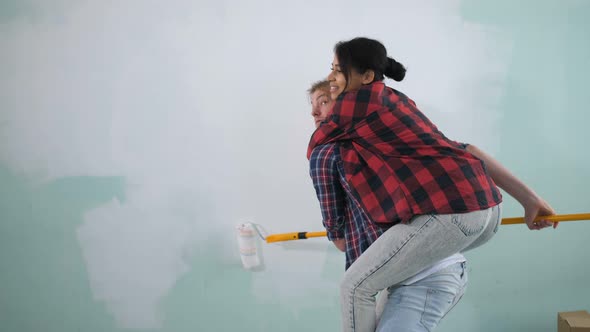 Woman Piggybacking Man During Renovation