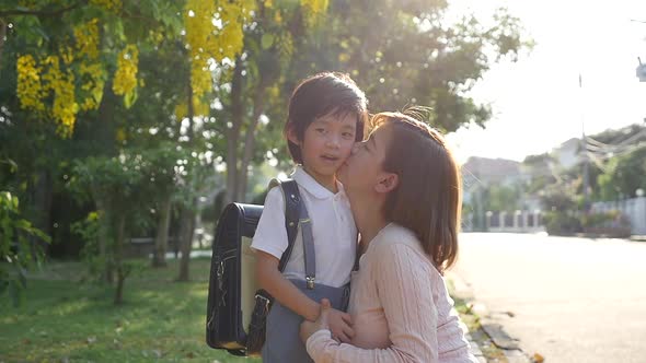 Asian Mother  Saying Goodbye To Her Son As He Leave For School