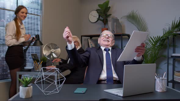 Cheerful Senior Company Boss or Manager Laughing and Being Surprised with Colleagues Team in Office