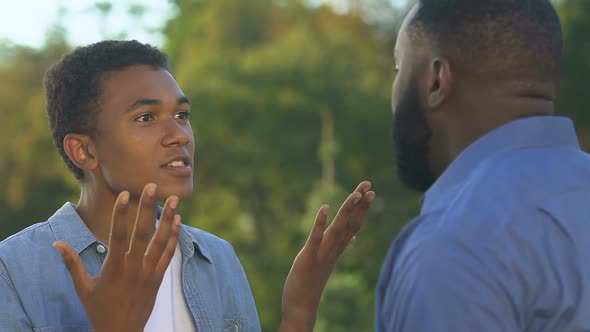 Afro-American Teenager Arguing With Father Having Own Opinion, Rebellious Age