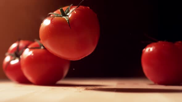 Fresh tomato bouncing on table. Slow Motion.