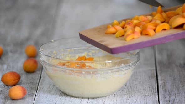 Chef add apricots to cake batter, The hand mix apricots with batter, Making apricots cake