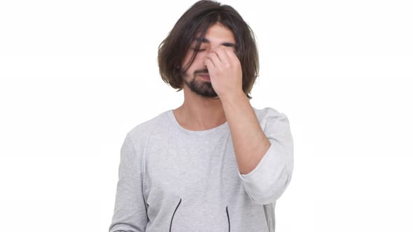 Longhaired Guy Wearily Rubbing Nose Bridge Isolated Over White Background