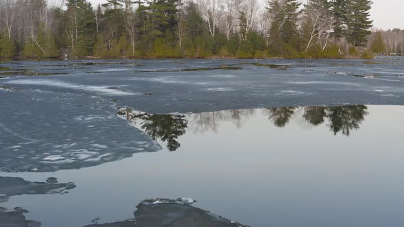 Hebron Lake in Monson Maine melting ice reflective water