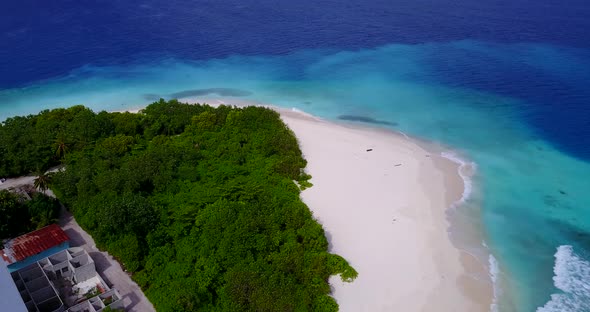 Tropical aerial travel shot of a white sandy paradise beach and aqua turquoise water background in c