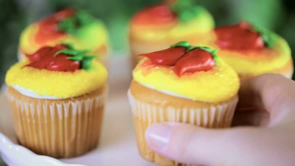 Cupcakes decorated with red chili peppers for Cinco de Mayo.