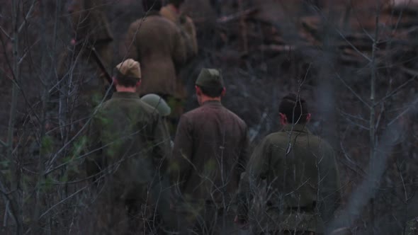 Soldiers Walking on the Scorched Ground of the Forest