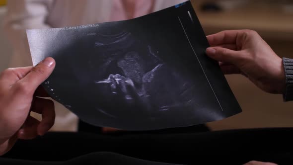 Hands of Future Parents with Ultrasound Picture