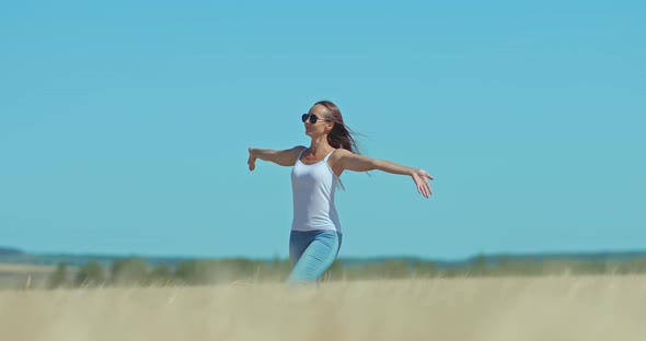 Beautiful Girl in Sunglasses Walks Through a Wheat Field Happy Moments of Life