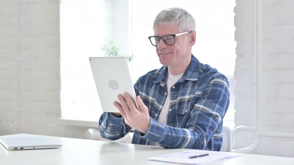 Hardworking Casual Middle Aged Man Using Tablet 