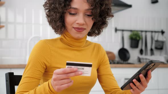 Close Up Woman Enters Credit Card Code to Pay Gifts Online Shopping Smartphone