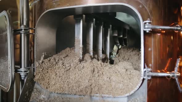 Mixing of malt in the brewing tank. Used malt after brewing beer process. Beer production concept