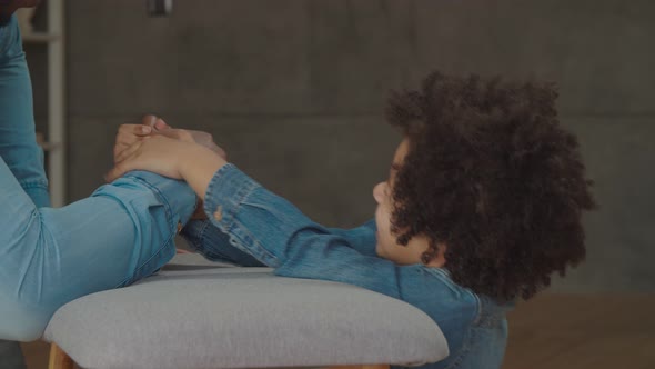 Joyful Son Defeating Father in Arm Wrestling Game