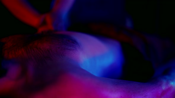 Masseuse is Massaging Abdomen of Male Client in Erotic Spa Salon Desire and Pleasure Closeup View