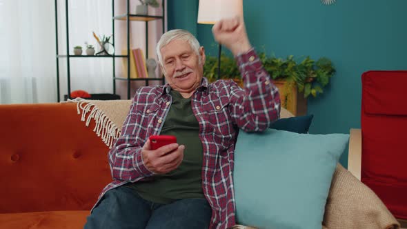Senior Grandfather Use Mobile Cell Phone Online Shopping Found Out Great Big Win Celebrate at Home