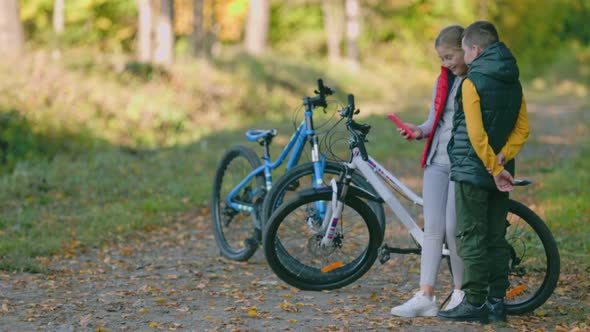 Children Look at the Phone While in Nature