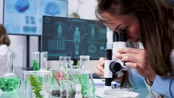 Close Up Shot of Female Biologist Looking Into the Microscope