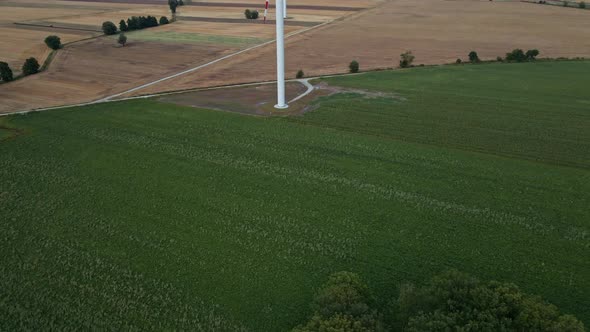 Windmill Turbine in the Field at Summer Day