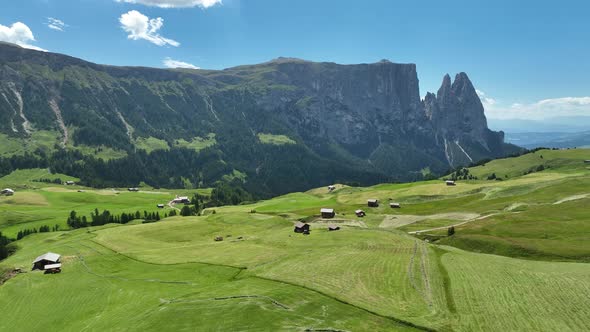 Wooden cottages under the mountains on a sunny summer day