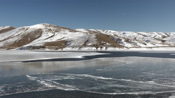 Frozen Water Surface of Lake Floe Melts in Spring