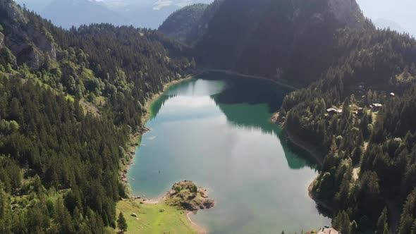 High overview of stunning lake surrounded by mountains and forest