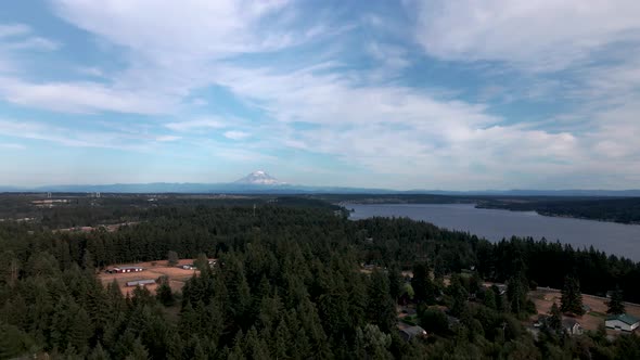 Mt Rainier, Wispy stratus clouds, forested suburban Washington, Puget Sound, aerial