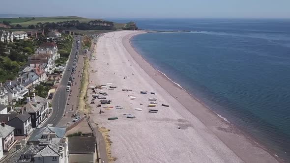 Soaring high parallel to shore in Budleigh Salterton, Jurassic Coast, AERIAL STATIC CROP