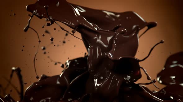 Super Slow Motion Shot of Splashing Melted Chocolate on Brown Gradient Background at 1000 Fps