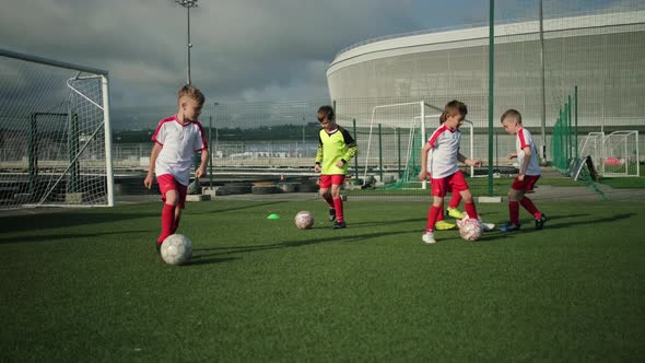 Little Boys Are Training on Football Field